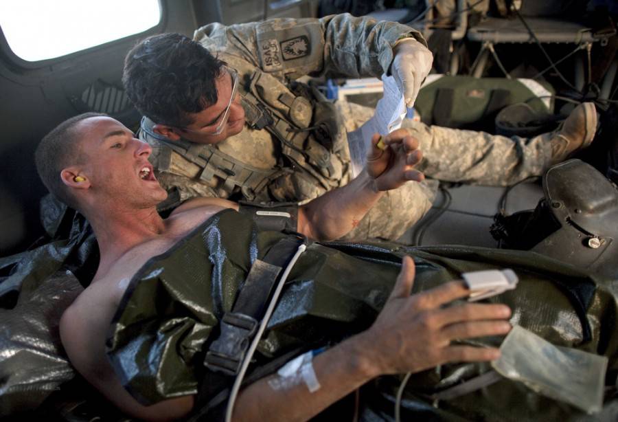 6. US Army medic Jaime Adams, right, listens as US Marine Corps soldier Chr...