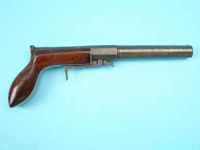 Pistola a capsula a colpo singolo con posizione di innesco inferiore (a martello)