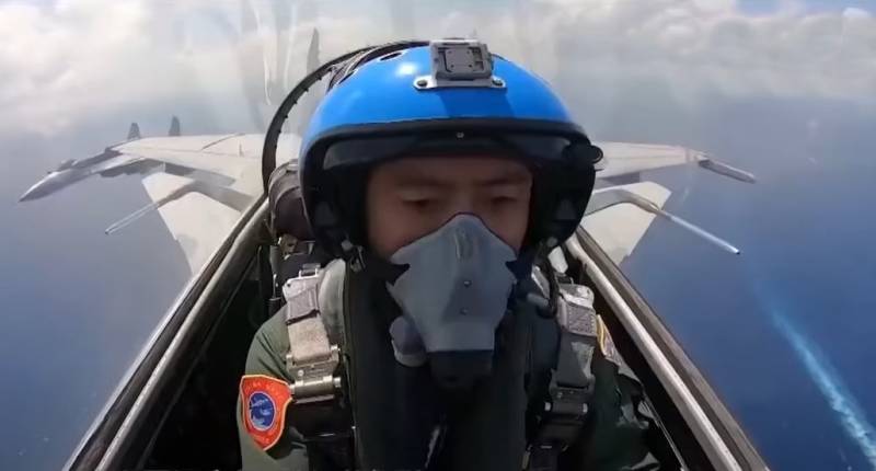 Chinese J-15 fighter jet flying over US Navy destroyer