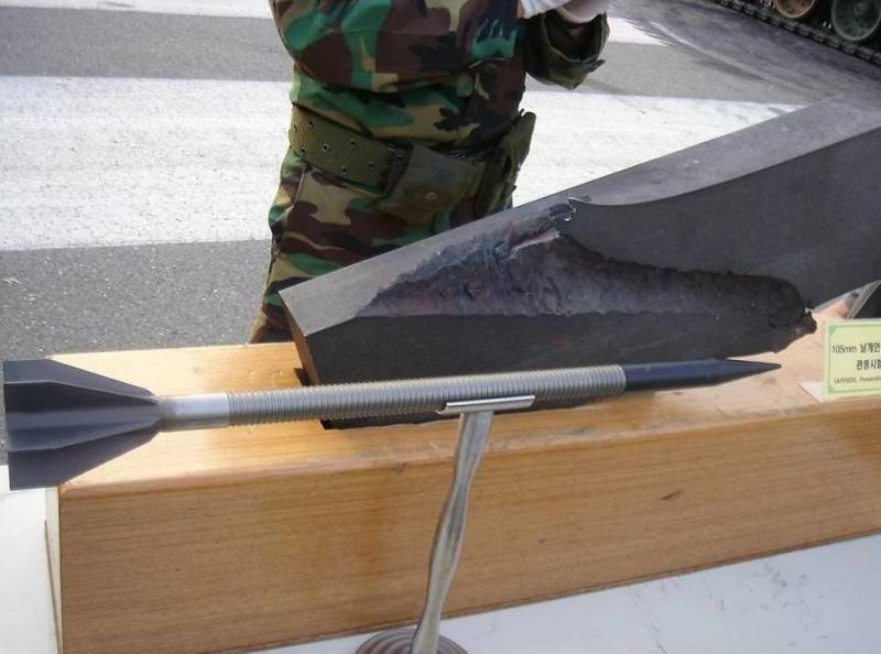 The active part of a Chinese 105-mm finned sub-caliber projectile and a pierced armor plate behind it. Source: dzen.ru