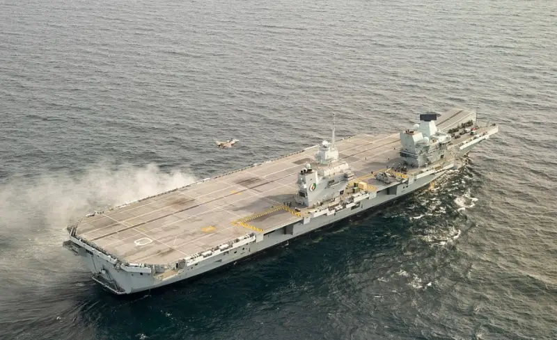 Ten sailors were injured in a fire on the Royal Navy's flagship aircraft carrier.
